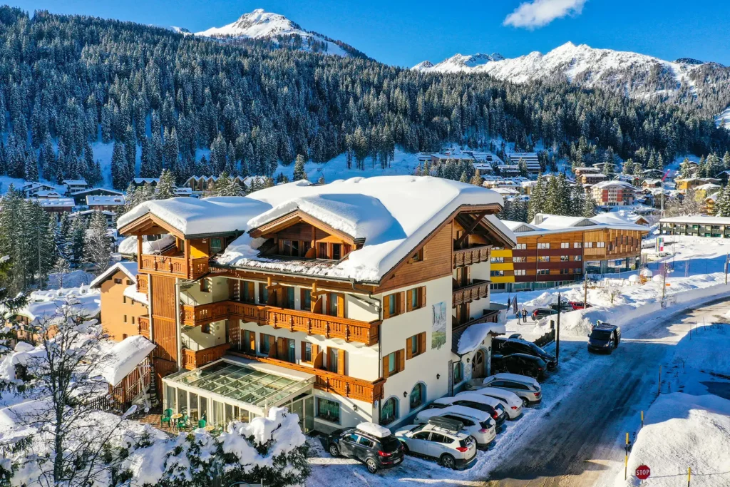 A snow-covered alpine chalet in a mountain village.